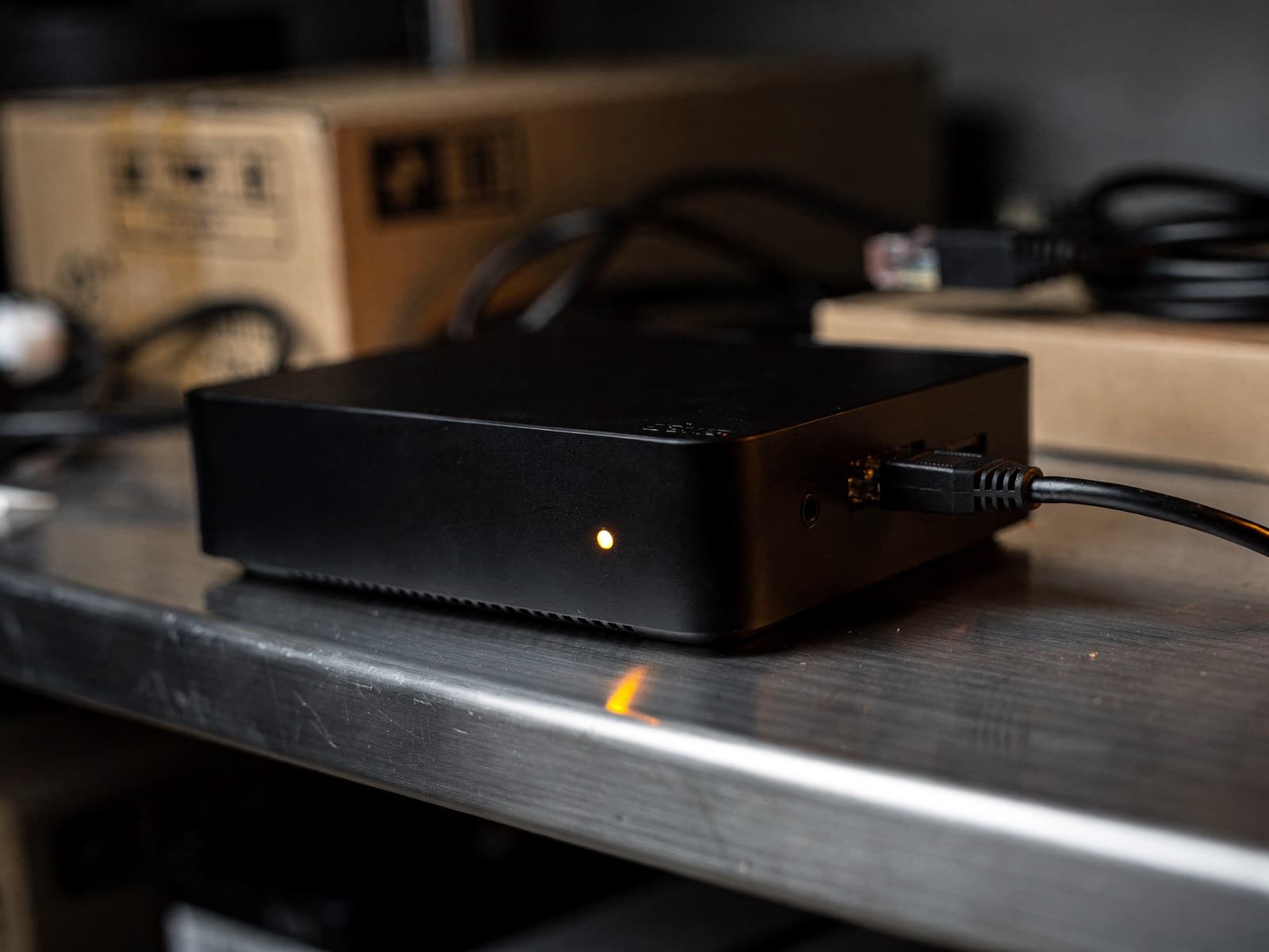 The Retail Theft box: a small black unit with a glowing status LED, on a shelf in a store back office